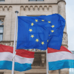 Luxembourg government building with EU flag representing public procurement opportunities for business contractors in 2025